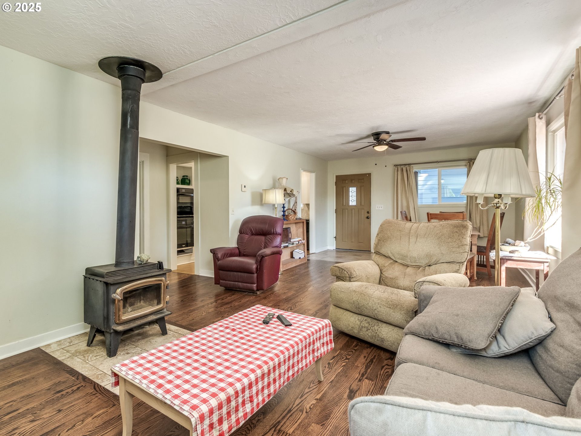 4731 Northeast 106th Avenue Portland, OR 97220 - Photo 12 of 44 a living room with furniture a rug and a chandelier