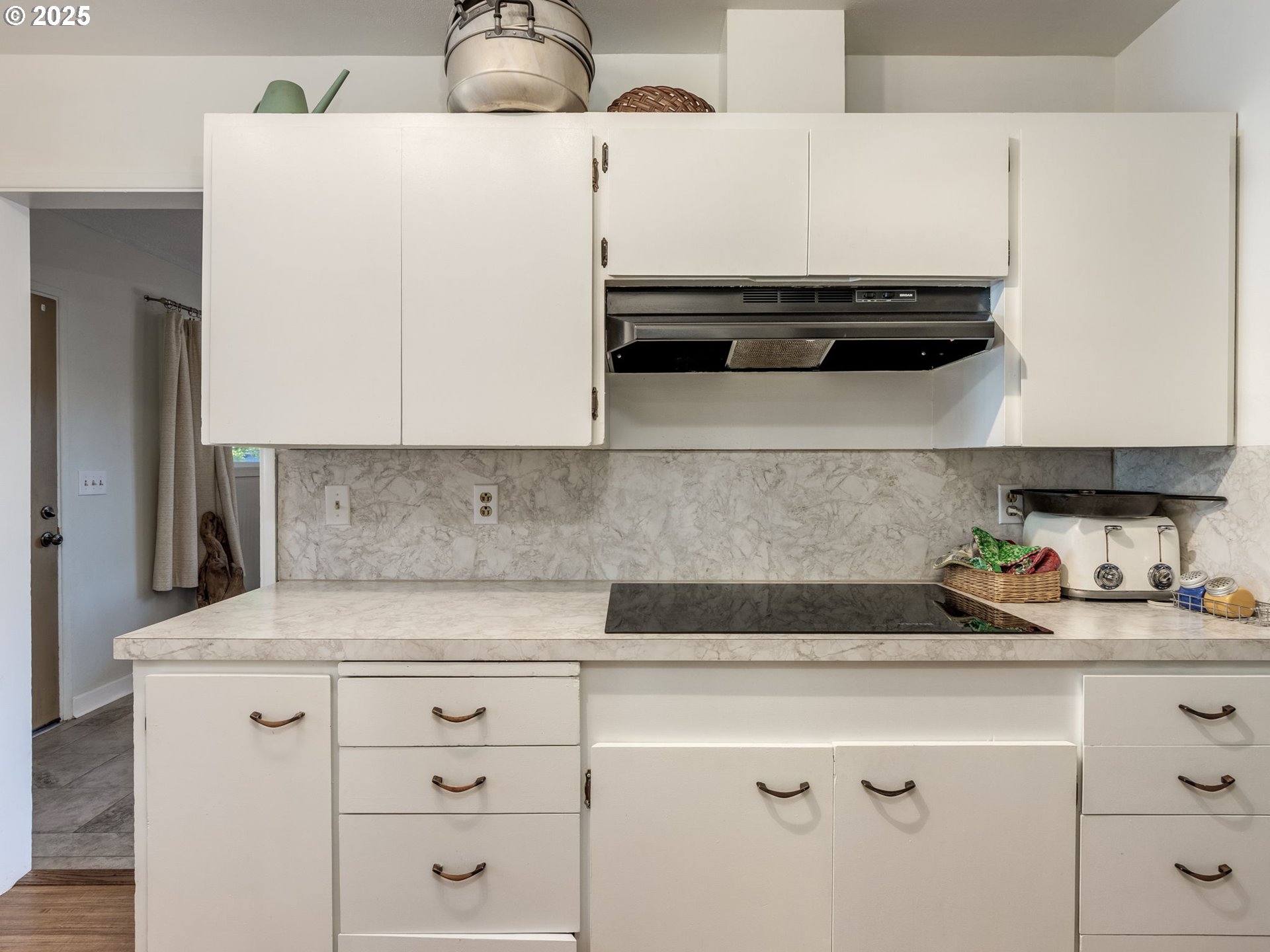 4731 Northeast 106th Avenue Portland, OR 97220 - Photo 19 of 44 a kitchen with stainless steel appliances a stove and white cabinets