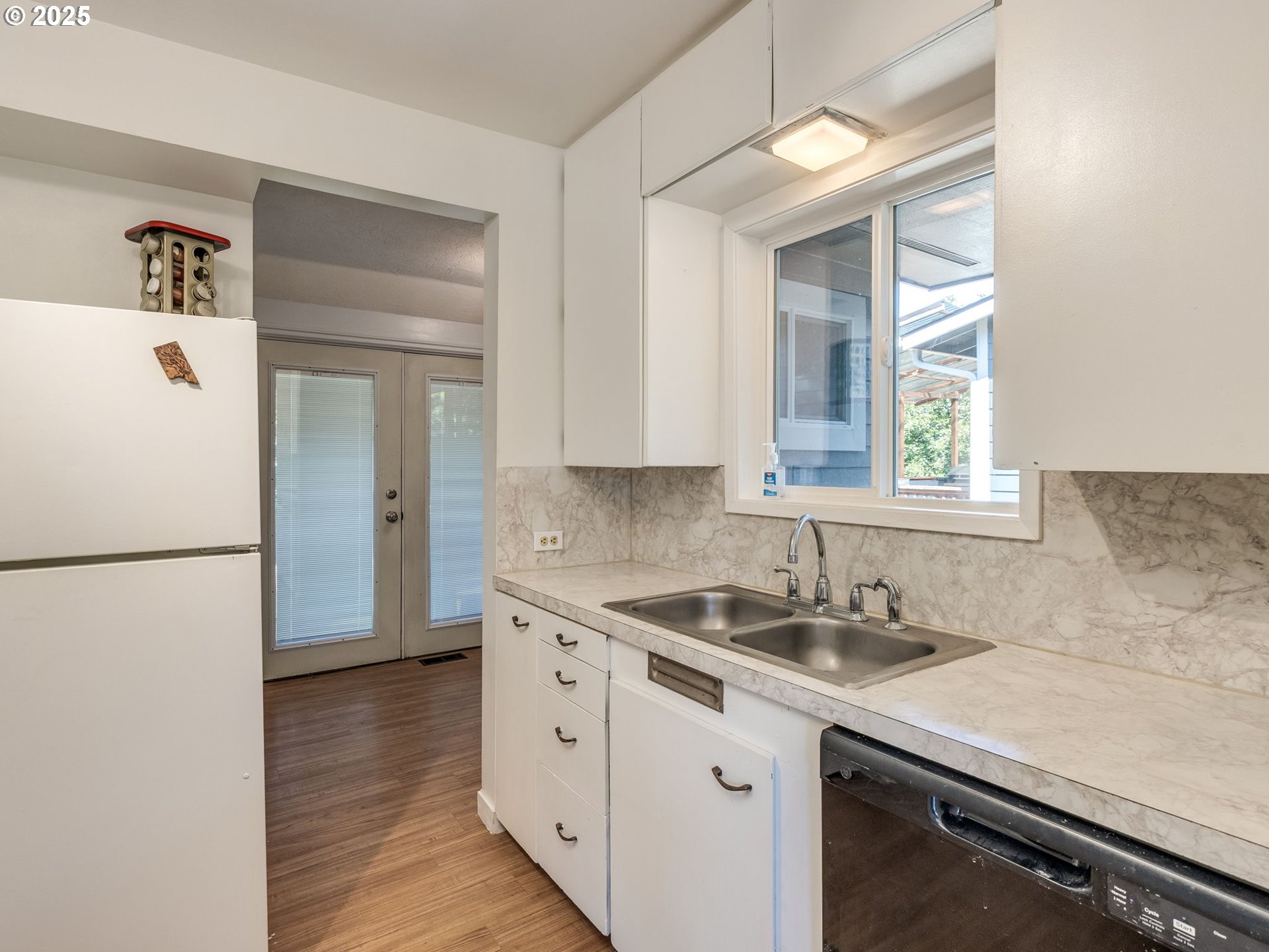 4731 Northeast 106th Avenue Portland, OR 97220 - Photo 20 of 44 a kitchen with a sink a refrigerator a stove and a window