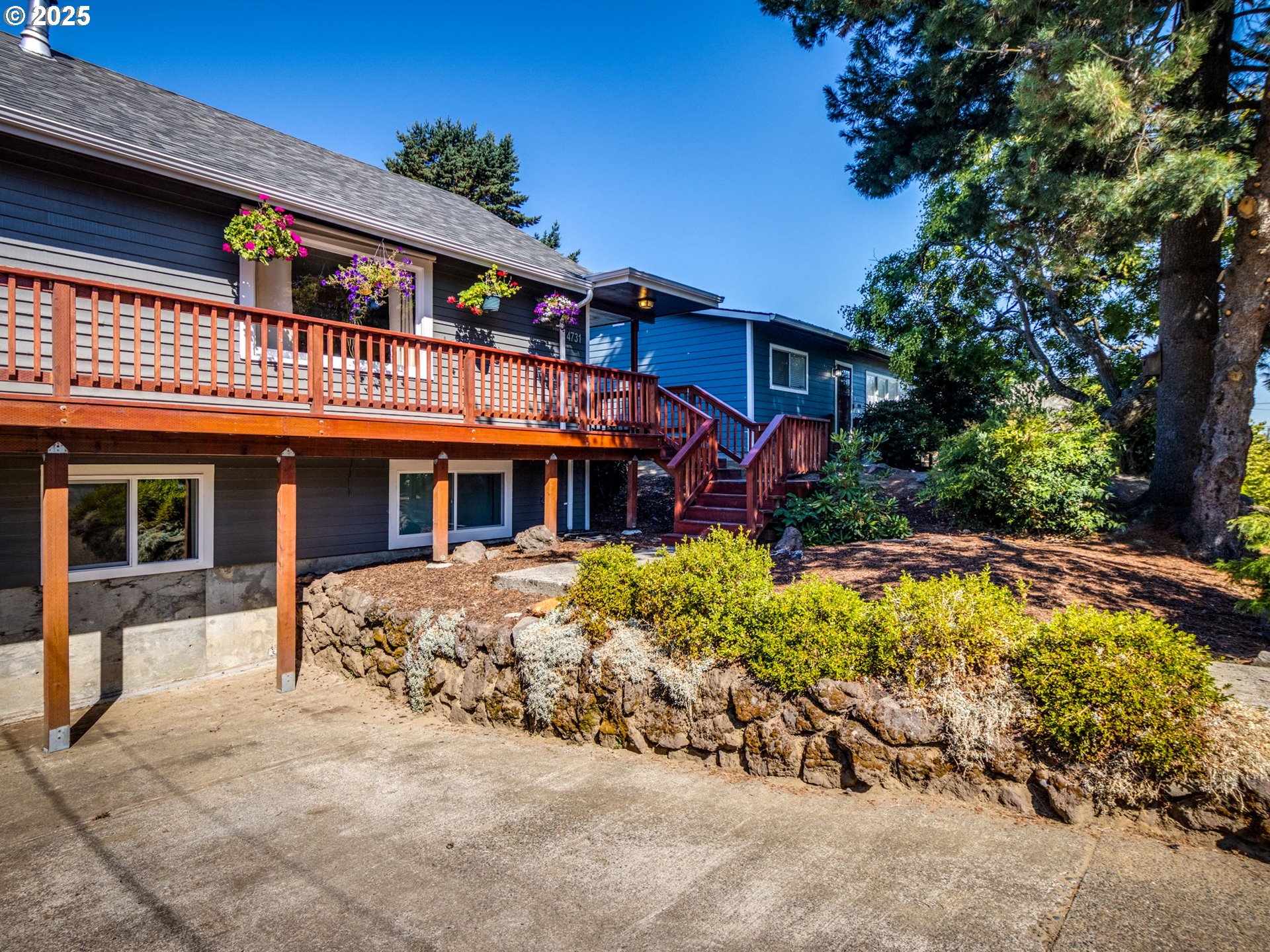 4731 Northeast 106th Avenue Portland, OR 97220 - Photo 2 of 44 a front view of a house with a yard patio and fire pit
