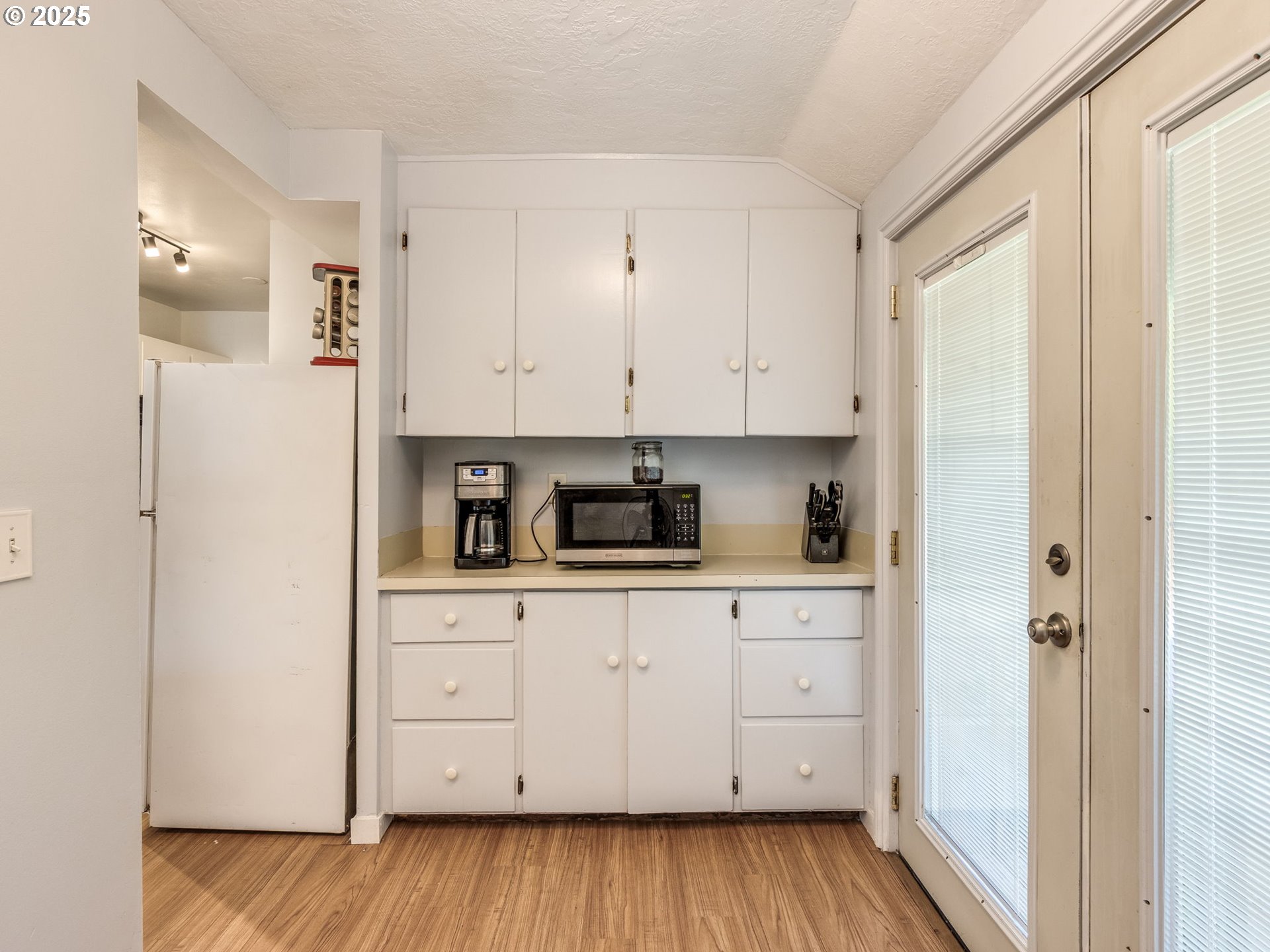 4731 Northeast 106th Avenue Portland, OR 97220 - Photo 24 of 44 a kitchen with stainless steel appliances white cabinets and wooden floors