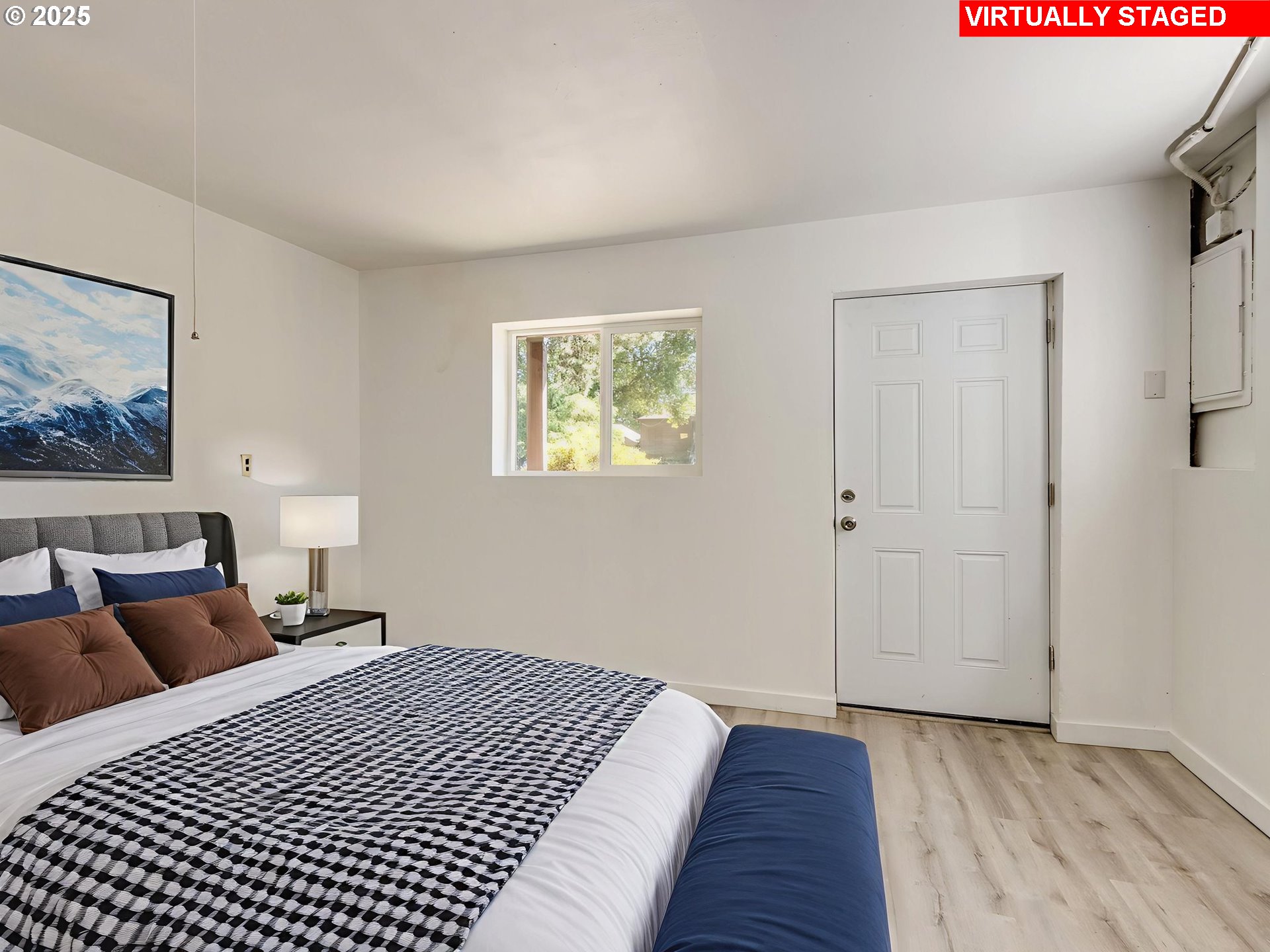 4731 Northeast 106th Avenue Portland, OR 97220 - Photo 32 of 44 a bedroom with a bed and a painting on the wall
