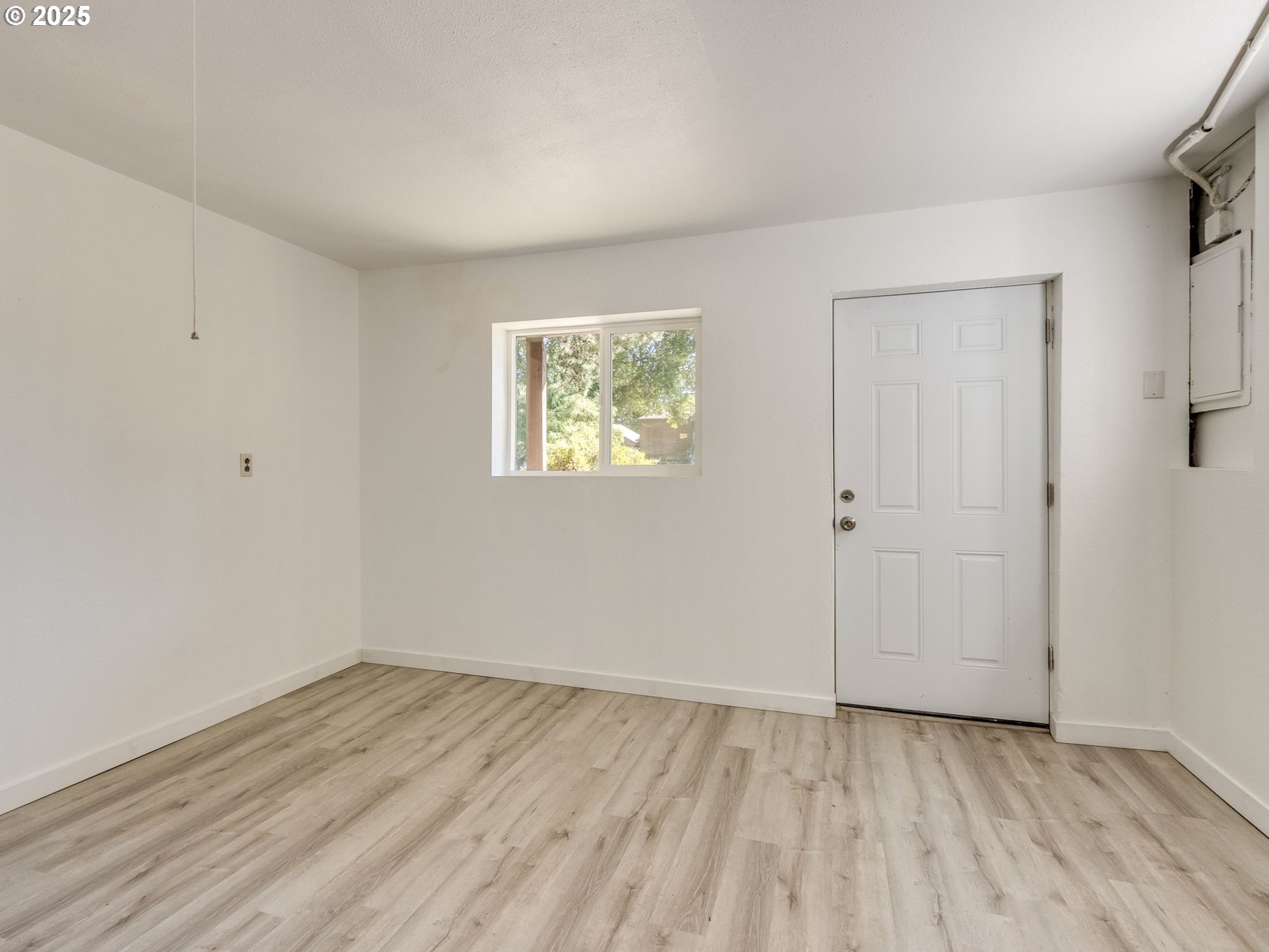 4731 Northeast 106th Avenue Portland, OR 97220 - Photo 33 of 44 a view of an empty room with wooden floor and a window