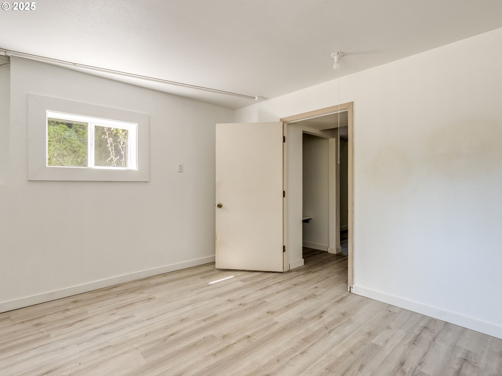 4731 Northeast 106th Avenue Portland, OR 97220 - Photo 35 of 44 an empty room with wooden floor and a window