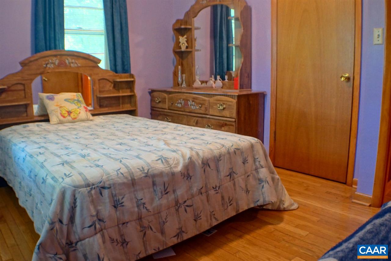 2000 Orange Road Pratts, VA 22731 - Photo 19 of 38 a spacious bedroom with a bed and wooden floor