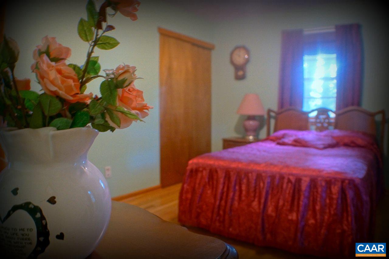 2000 Orange Road Pratts, VA 22731 - Photo 23 of 38 a bedroom with a bed and a painting on the wall