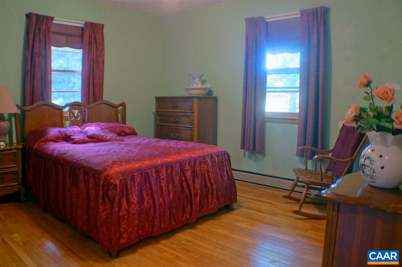 2000 Orange Road Pratts, VA 22731 - Photo 25 of 38 a bed sitting in a bedroom next to a window