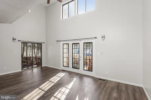 wooden floor in an empty room with windows