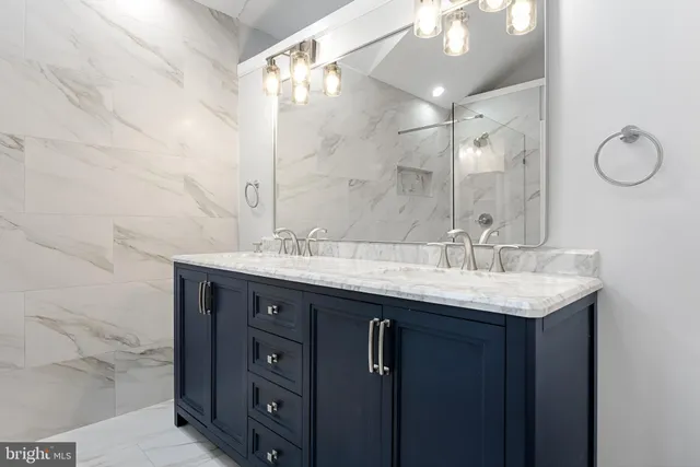 a bathroom with a double vanity sink and a mirror
