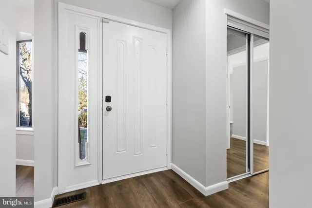 a view of an entryway with wooden floor