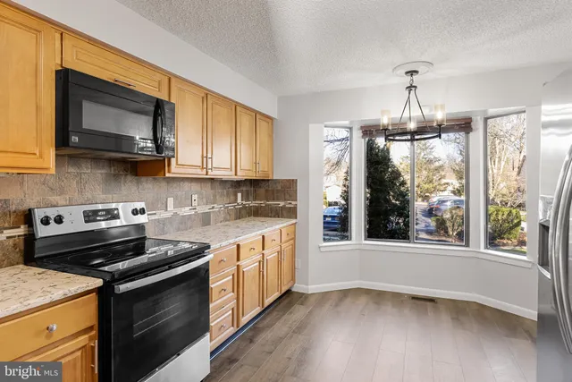 a kitchen with a stove a sink and a microwave