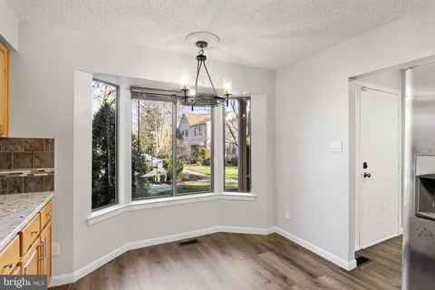 a very nice looking room with a window and wooden floor