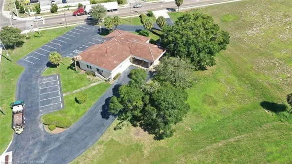 an aerial view of a house with a yard basket ball court