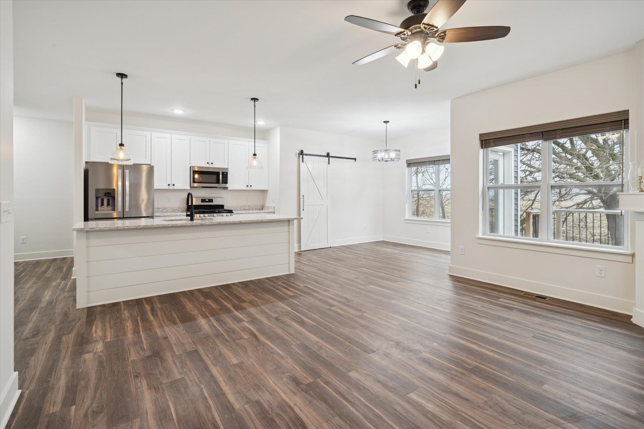 505 Anjali Court Sycamore, IL 60178 - Photo 16 of 47 a large kitchen with cabinets wooden floor and a window