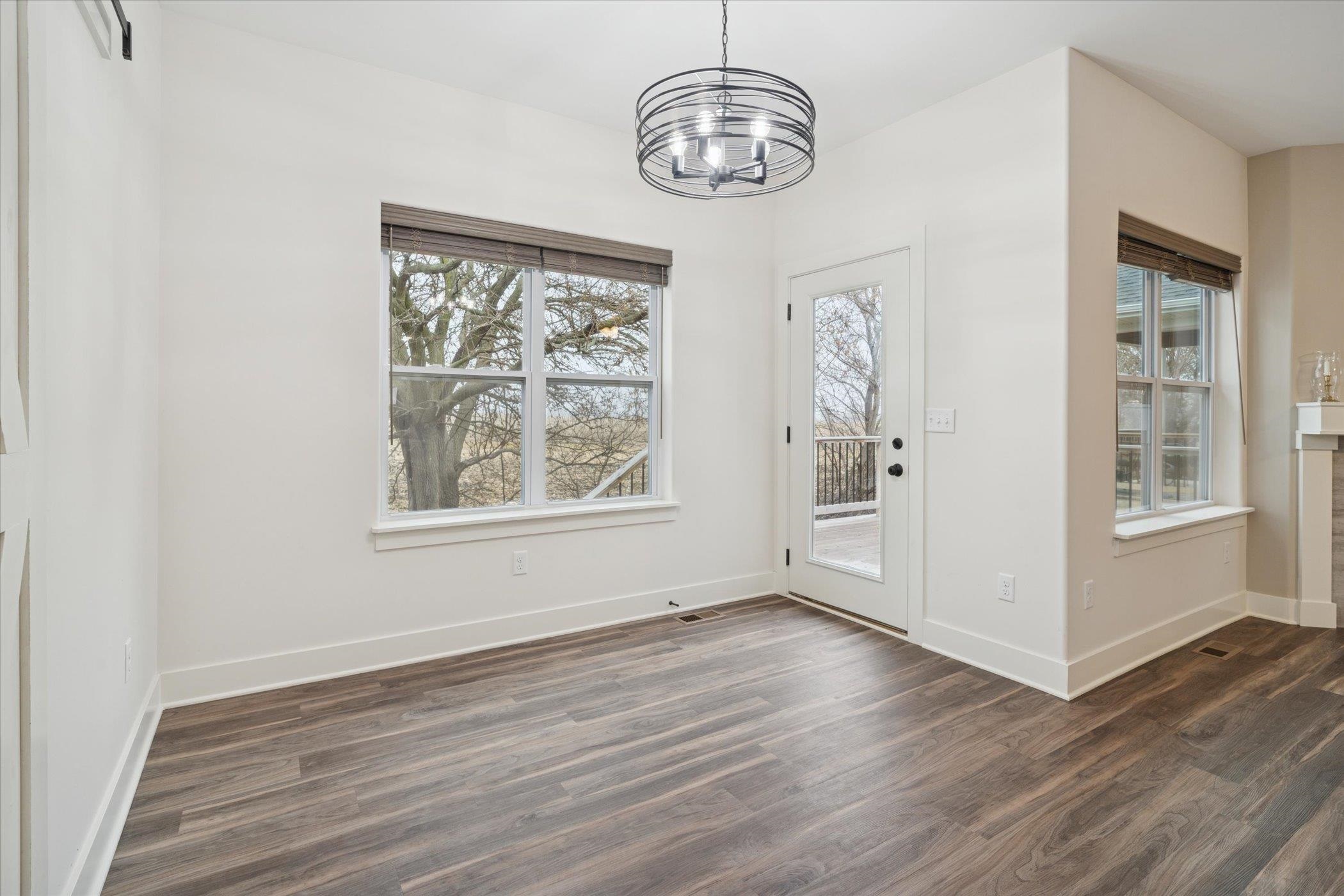505 Anjali Court Sycamore, IL 60178 - Photo 19 of 47 a view of an empty room with wooden floor and a window