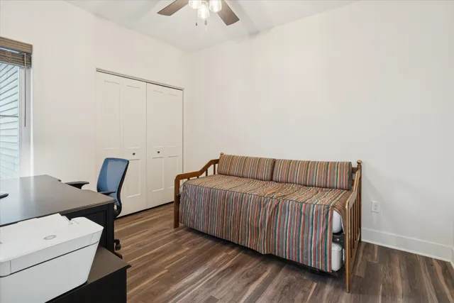 a bedroom with furniture and wooden floor