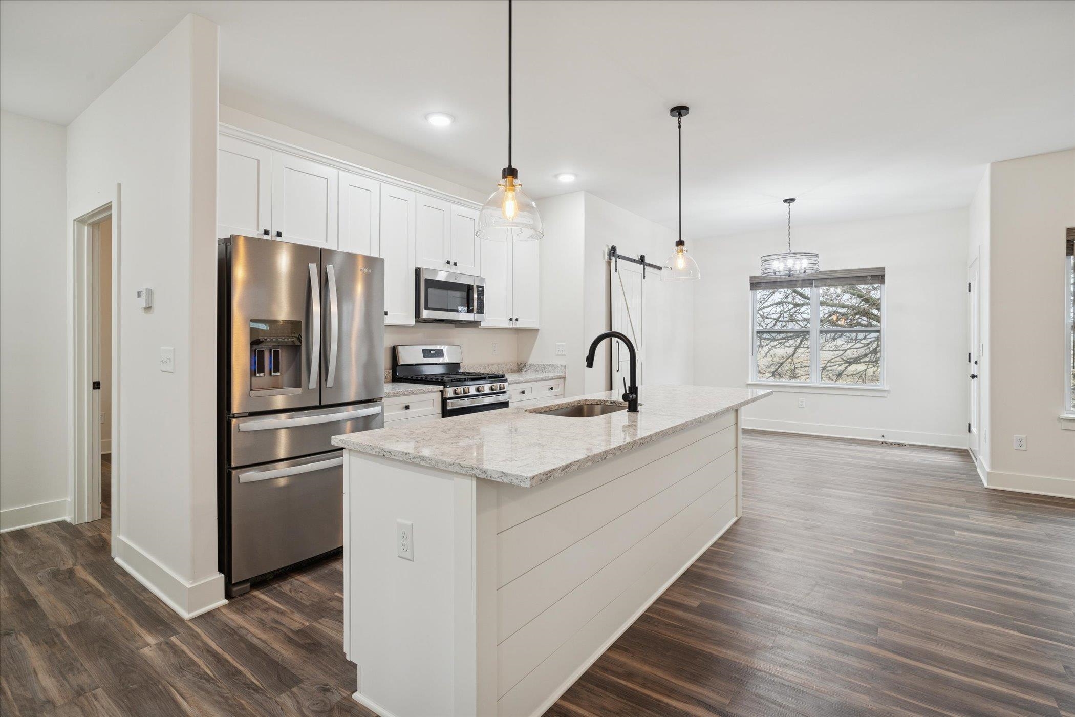 505 Anjali Court Sycamore, IL 60178 - Photo 30 of 47 a kitchen with stainless steel appliances a refrigerator a sink dishwasher a oven and white cabinets with wooden floor