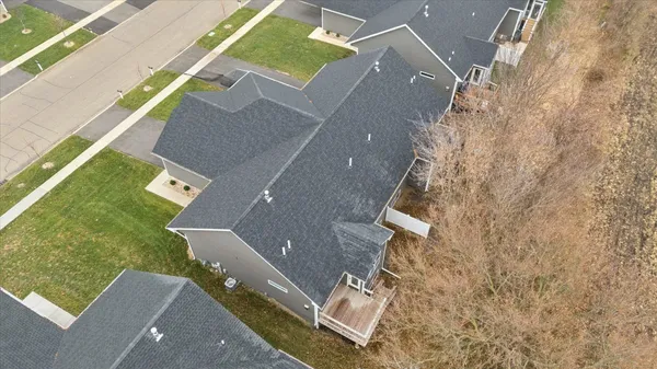 an aerial view of residential houses with outdoor space