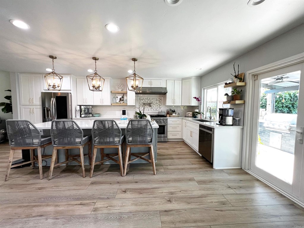 3583 Hatfield Circle Oceanside, CA 92056 - Photo 12 of 32 a large kitchen with lots of counter space and dining table