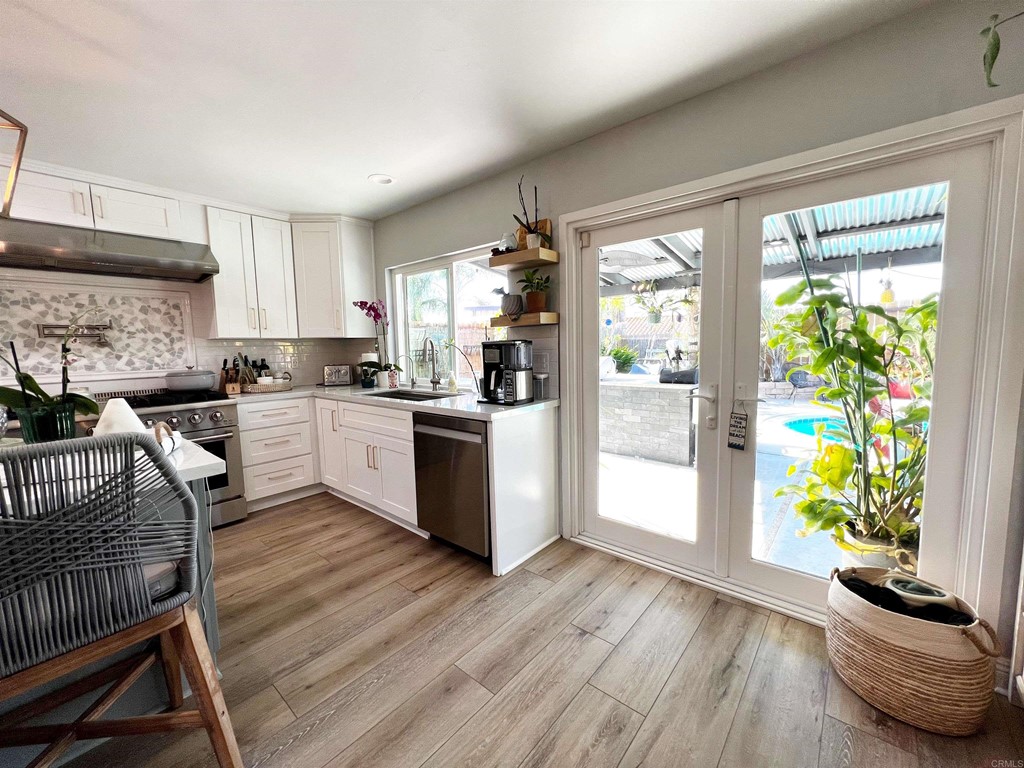 3583 Hatfield Circle Oceanside, CA 92056 - Photo 13 of 32 a kitchen with stainless steel appliances a stove a sink a refrigerator cabinets and a window