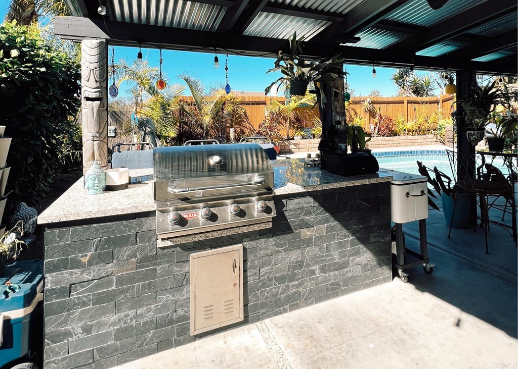3583 Hatfield Circle Oceanside, CA 92056 - Photo 17 of 32 a stove top oven a table and chairs in front of the house