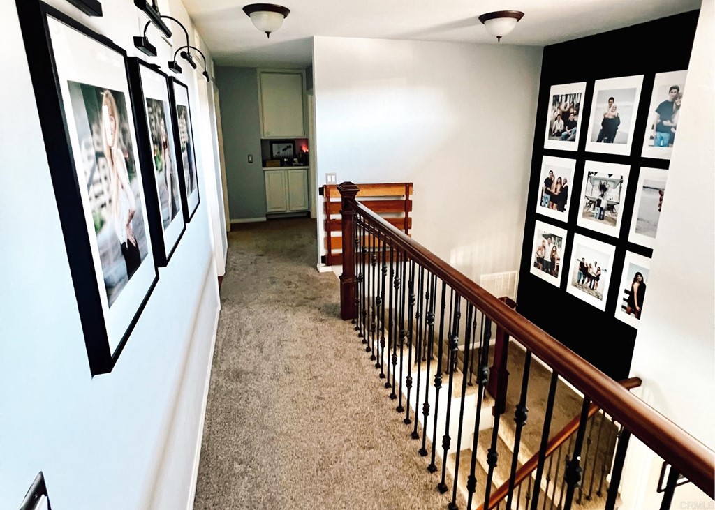 3583 Hatfield Circle Oceanside, CA 92056 - Photo 25 of 32 a view of a hallway with wooden floor and stairs