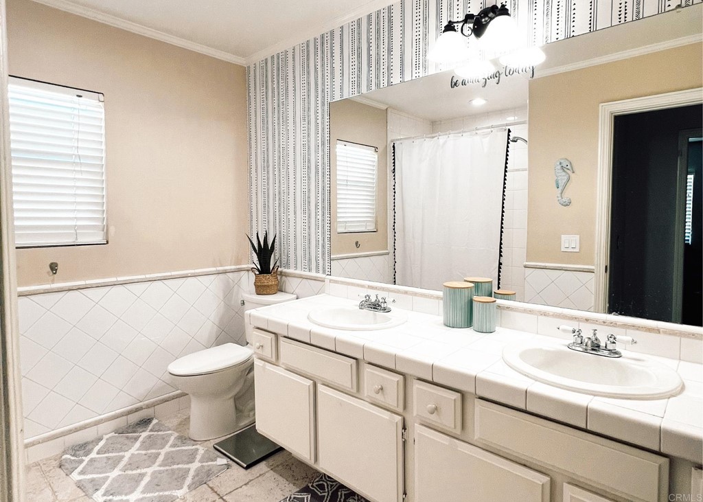 3583 Hatfield Circle Oceanside, CA 92056 - Photo 27 of 32 a bathroom with a double vanity sink mirror and toilet