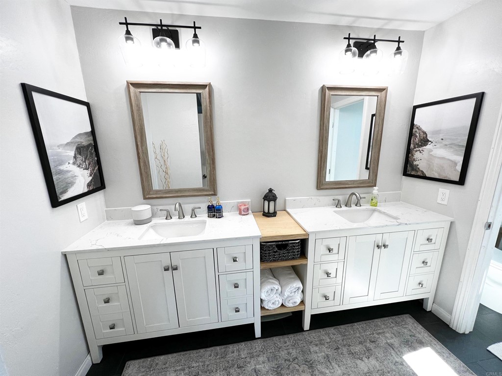 3583 Hatfield Circle Oceanside, CA 92056 - Photo 30 of 32 a bathroom with a double vanity sink and mirror