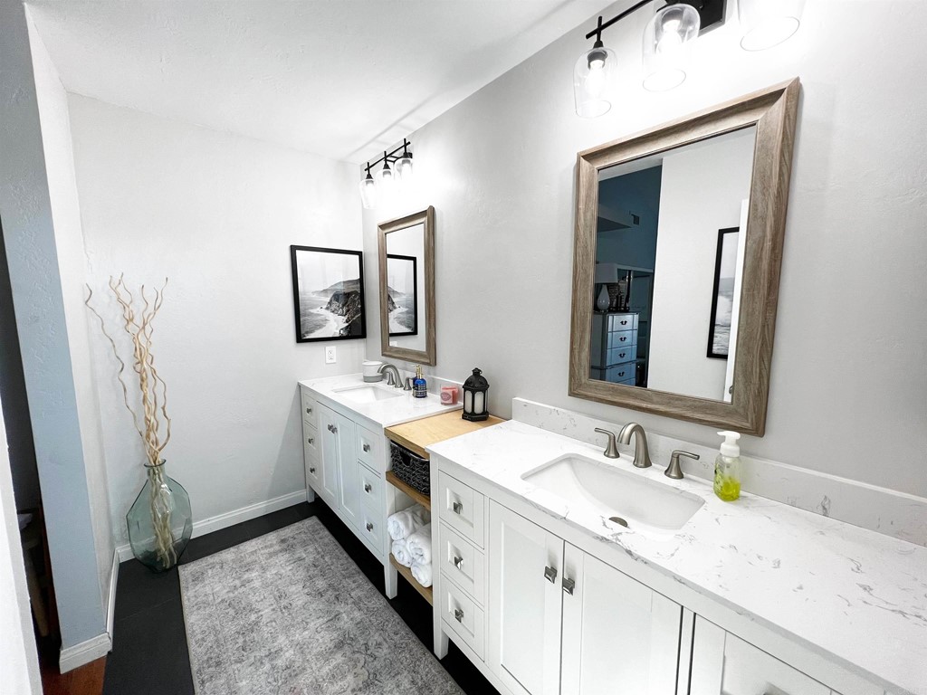 3583 Hatfield Circle Oceanside, CA 92056 - Photo 31 of 32 a spacious bathroom with a double vanity sink and a mirror