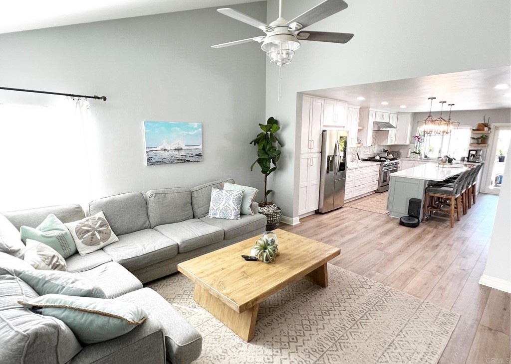 3583 Hatfield Circle Oceanside, CA 92056 - Photo 7 of 32 a living room with furniture wooden floor and a chandelier