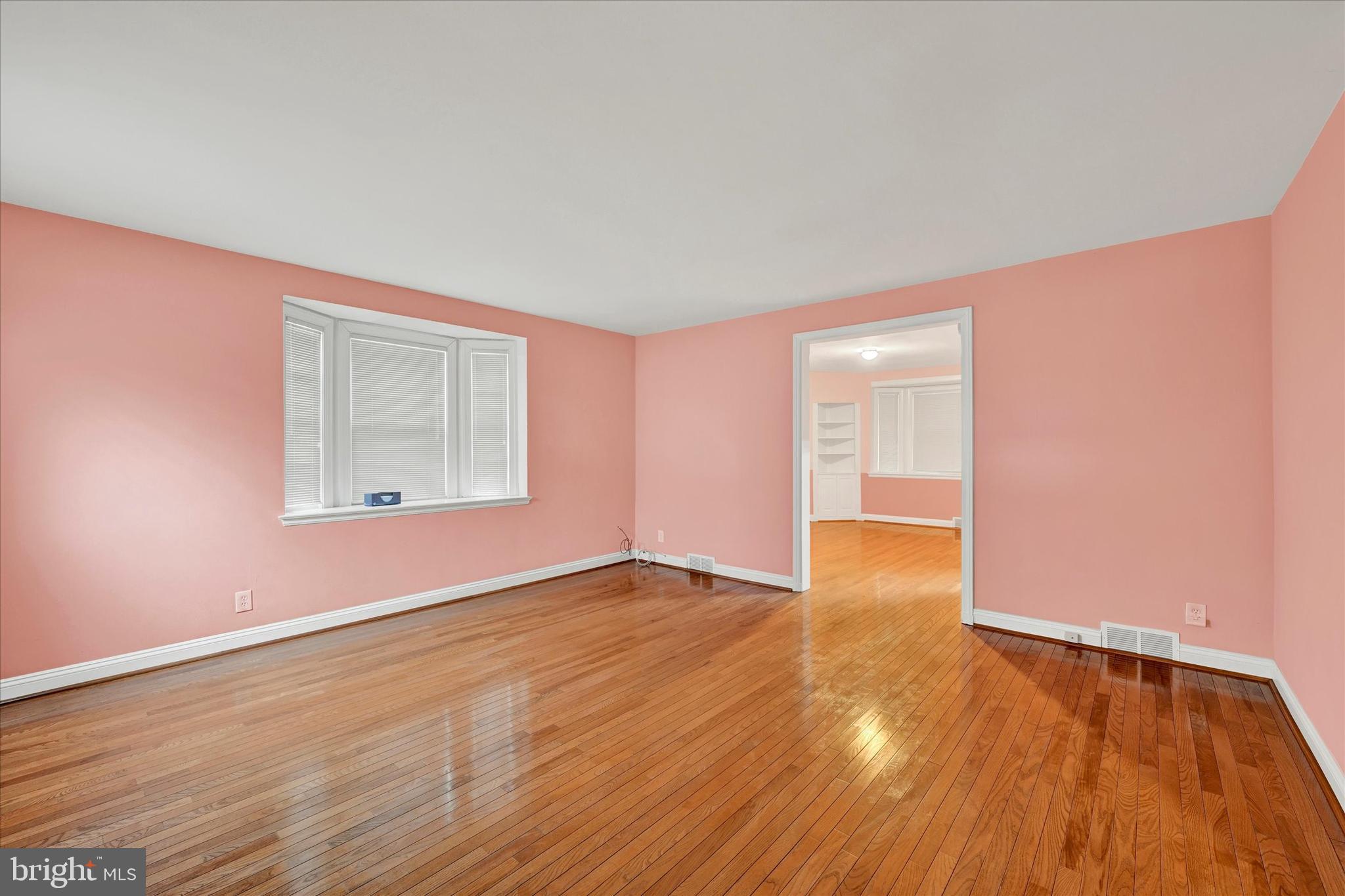 4010 Brookhill Road Baltimore, MD 21215 - Photo 8 of 26 a view of an empty room with wooden floor and a window