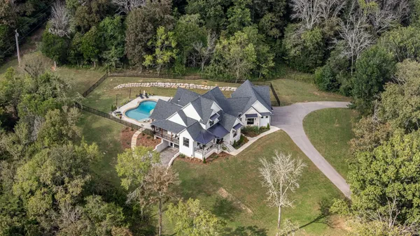 an aerial view of a house with a yard
