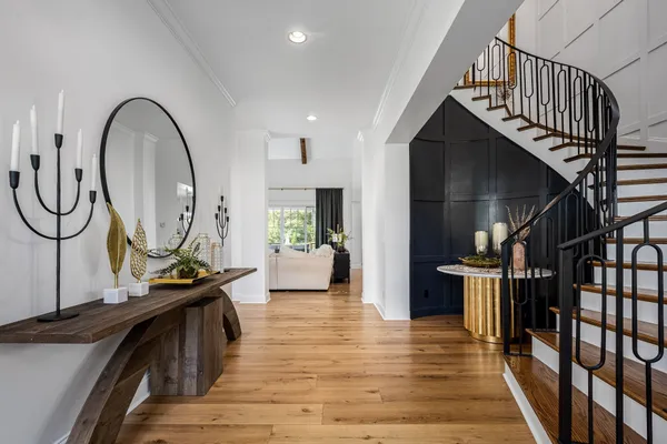 a large kitchen with stainless steel appliances kitchen island a large counter top a stove a refrigerator and a sink