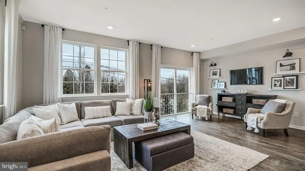 a living room with furniture and large windows