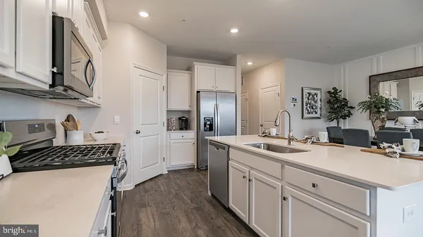 a kitchen with a sink stove and refrigerator
