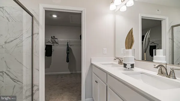 a bathroom with a double vanity sink and a mirror