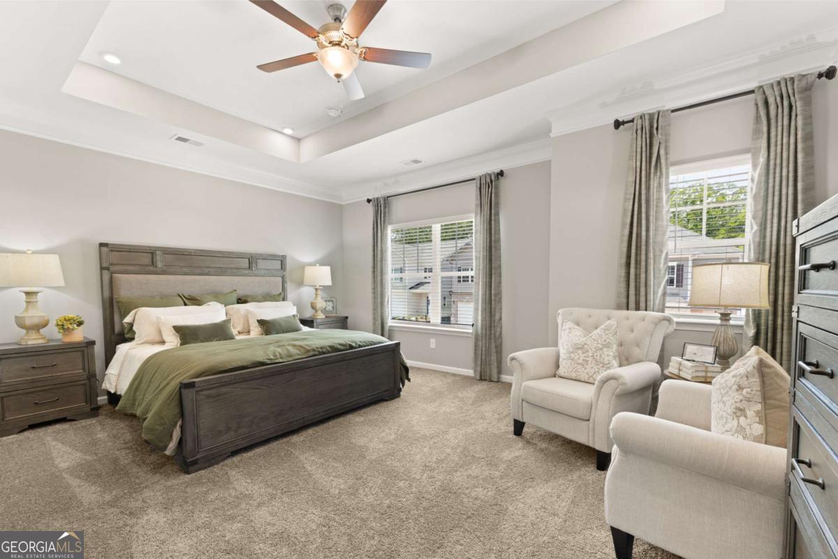 1429 Trellis Court, Unit (LOT 9) Hampton, GA 30228 - Photo 14 of 28 a bedroom with a bed couches and window