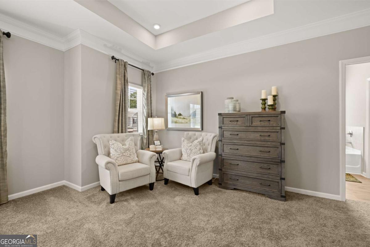 1429 Trellis Court, Unit (LOT 9) Hampton, GA 30228 - Photo 15 of 28 a living room with furniture and a dresser