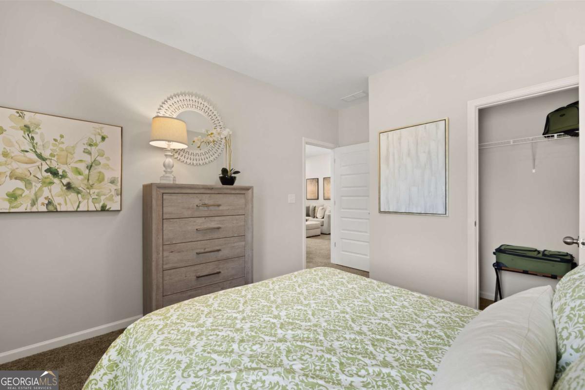 1429 Trellis Court, Unit (LOT 9) Hampton, GA 30228 - Photo 24 of 28 a bedroom with a bed and a dresser