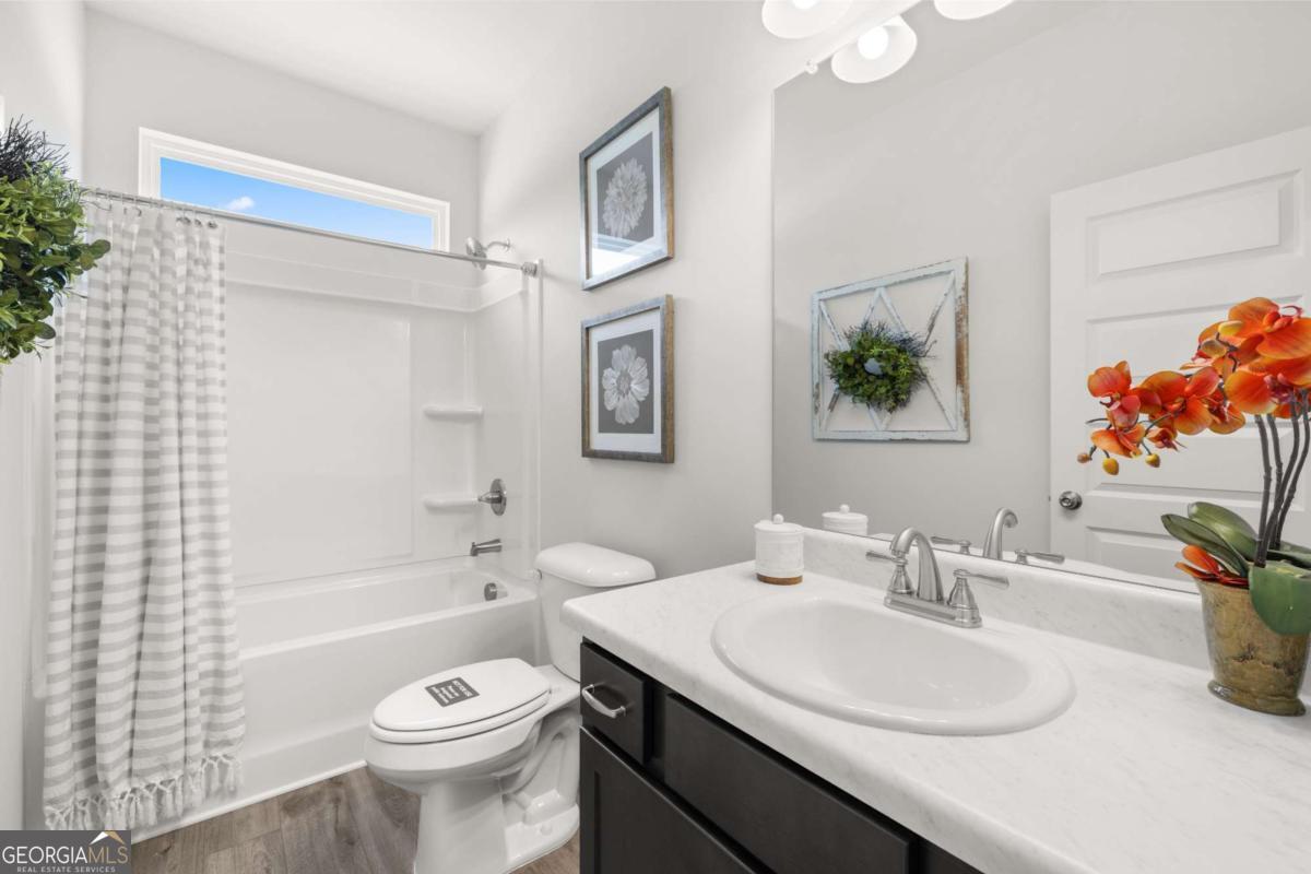 1429 Trellis Court, Unit (LOT 9) Hampton, GA 30228 - Photo 27 of 28 a bathroom with a sink a toilet and a bathtub