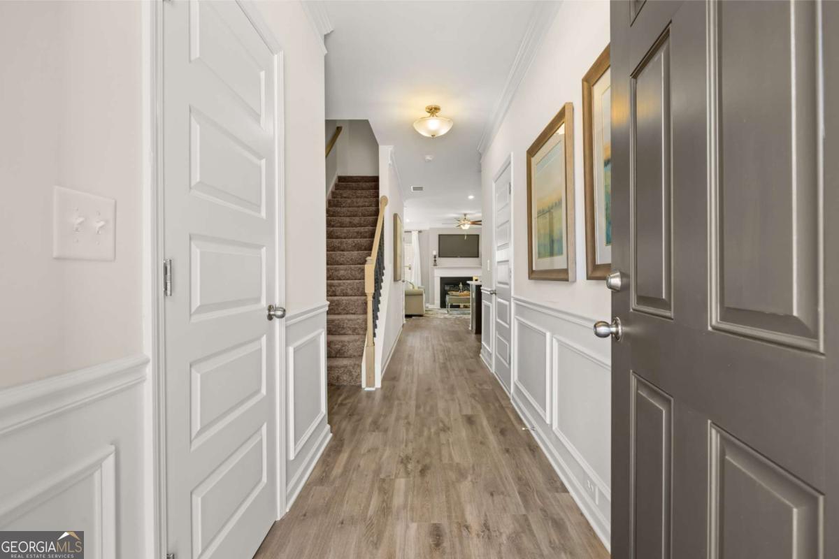 1429 Trellis Court, Unit (LOT 9) Hampton, GA 30228 - Photo 3 of 28 a view of a hallway with wooden floor and staircase