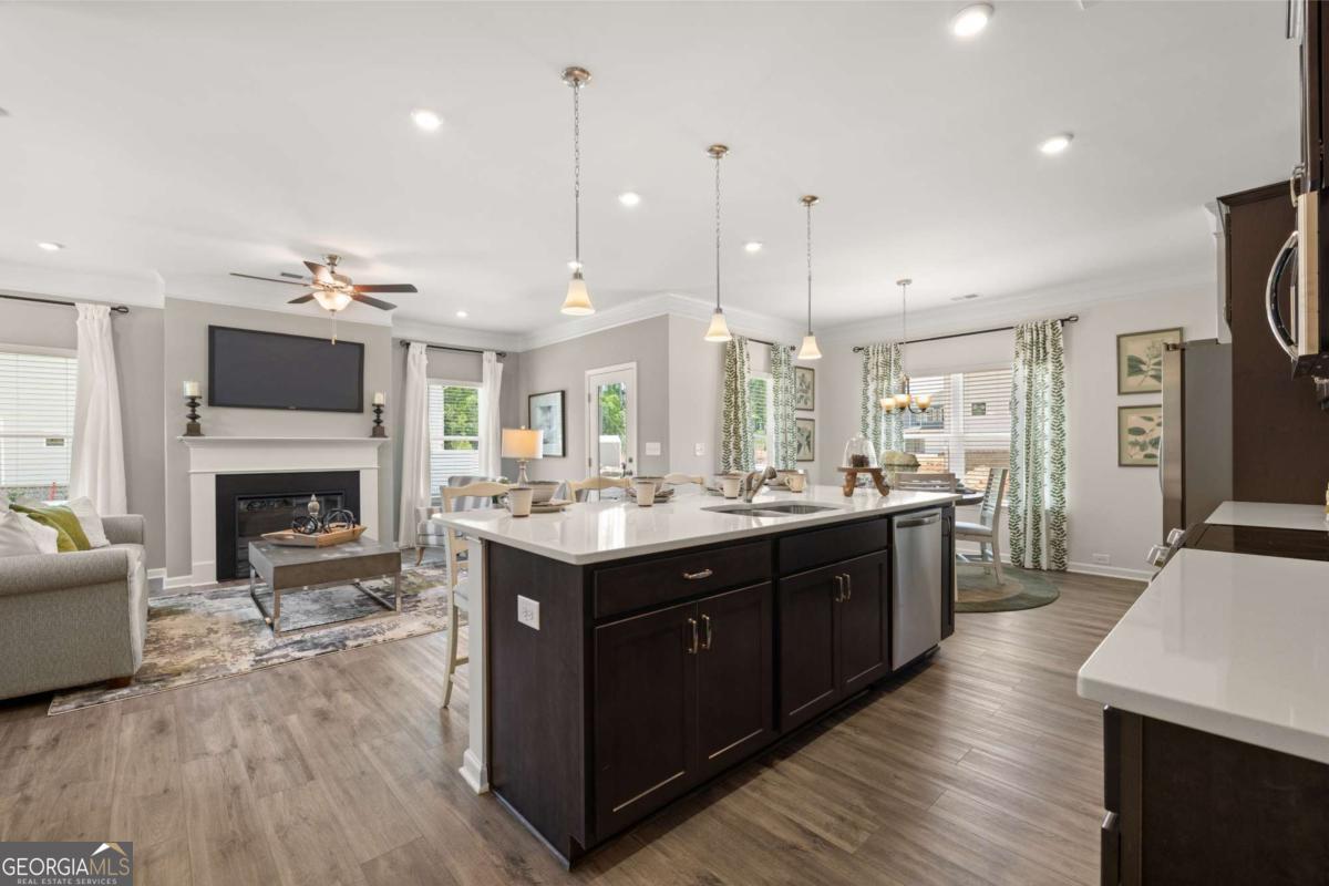 1429 Trellis Court, Unit (LOT 9) Hampton, GA 30228 - Photo 4 of 28 a large kitchen with cabinets a counter top space a sink stainless steel appliances and cabinets