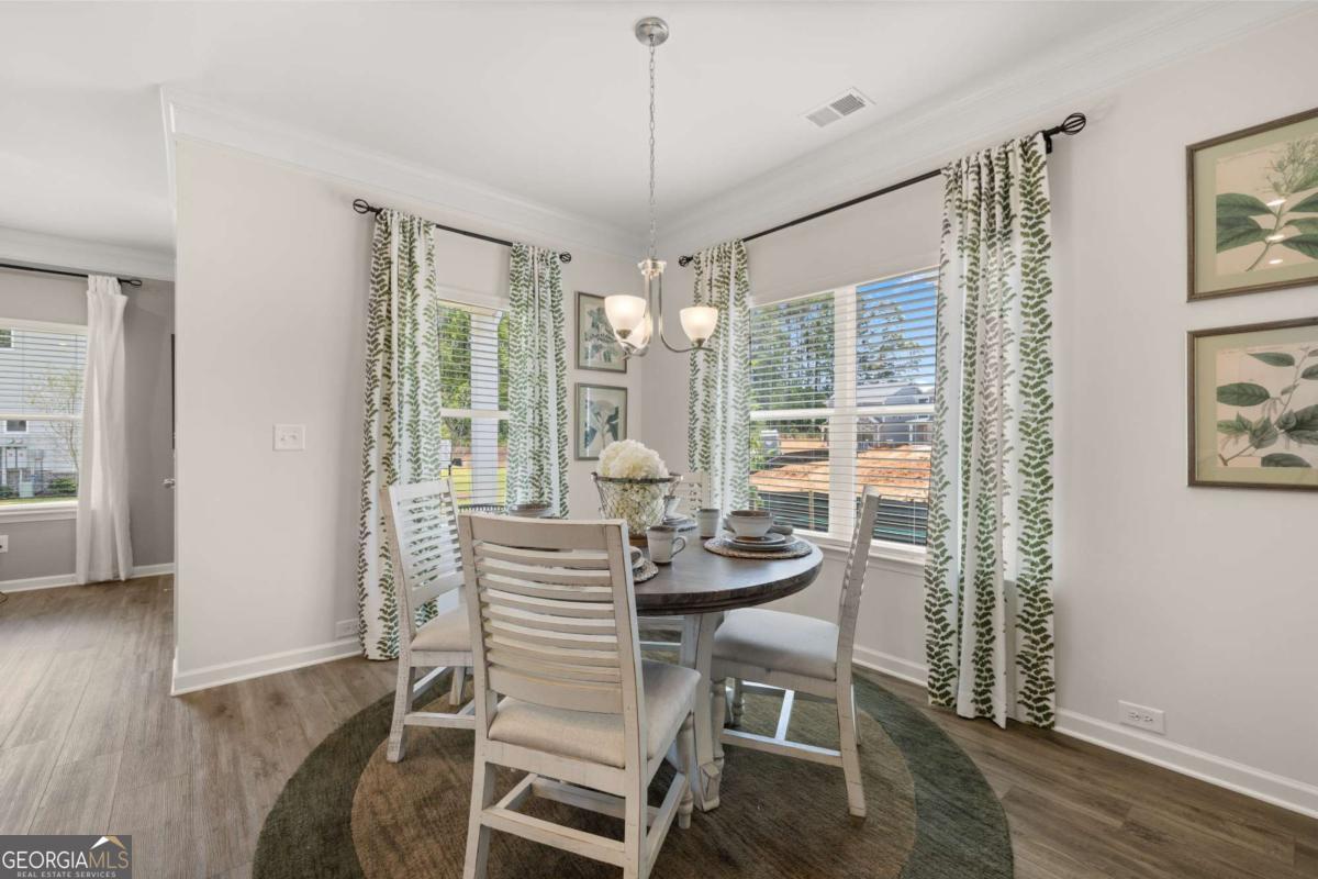 1429 Trellis Court, Unit (LOT 9) Hampton, GA 30228 - Photo 8 of 28 a dining room with furniture and window