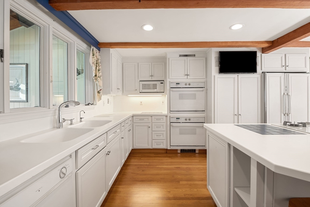 21 Topsfield Road Boxford, MA 01921 - Photo 12 of 42 a open kitchen with white cabinets sink and white stainless steel appliances