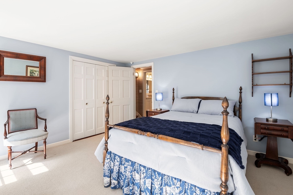 21 Topsfield Road Boxford, MA 01921 - Photo 27 of 42 a bedroom with a bed a mirror and a lamp on table