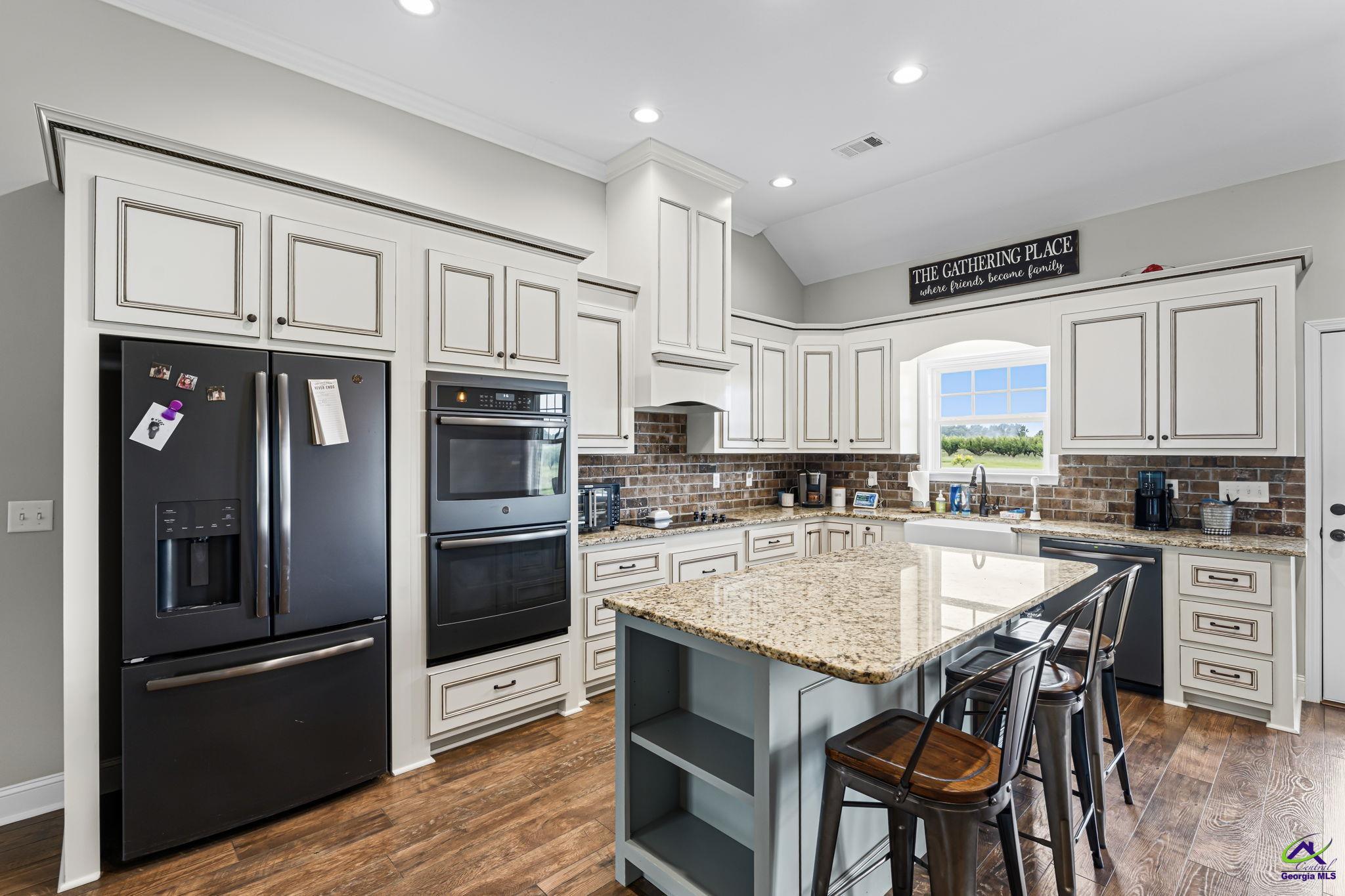 180 Woodland Trail Road Cochran, GA 31014 - Photo 9 of 25 a kitchen with stainless steel appliances granite countertop a refrigerator and a stove top oven