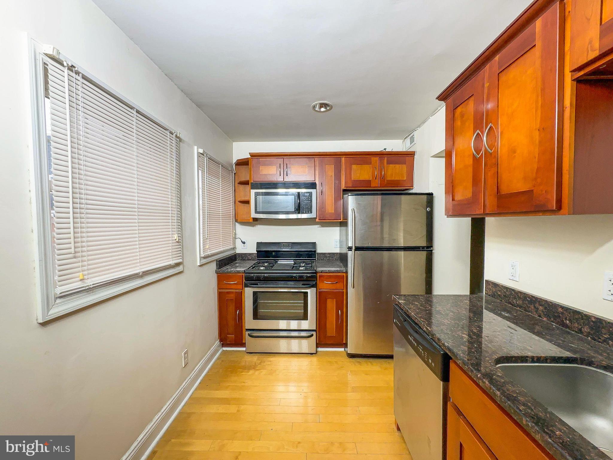 1835 D Street Northeast Washington, DC 20002 - Photo 20 of 42 a kitchen with stainless steel appliances granite countertop a refrigerator a stove top oven a sink and dishwasher