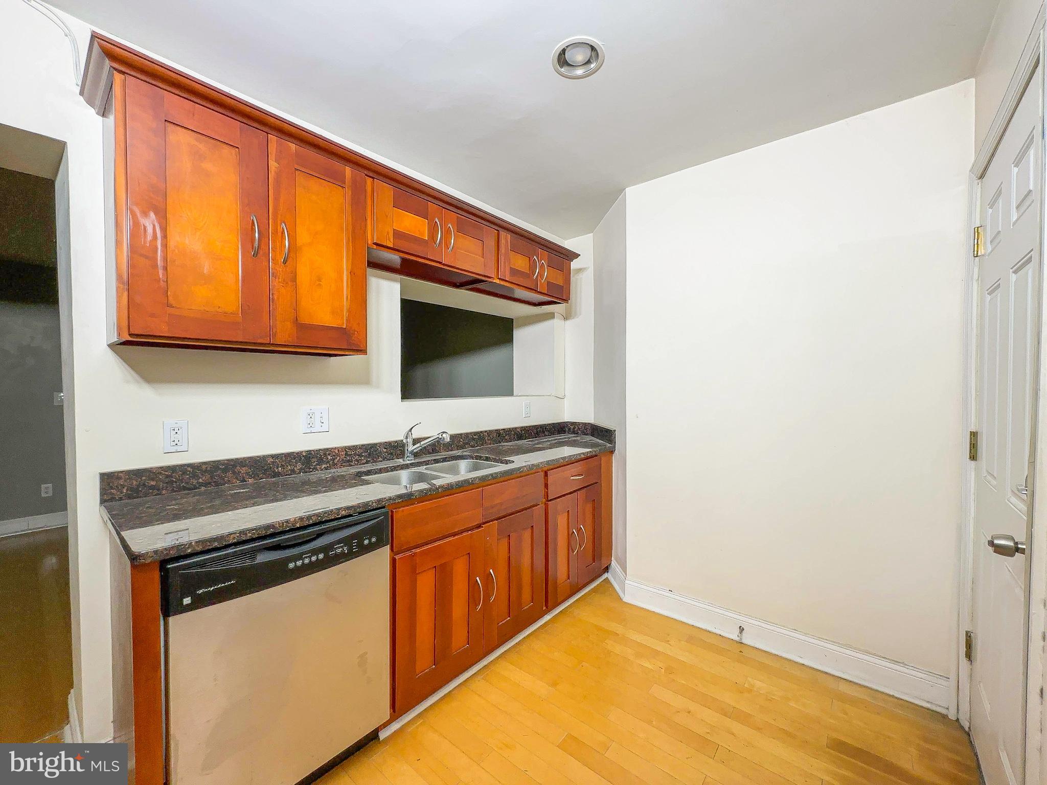 1835 D Street Northeast Washington, DC 20002 - Photo 21 of 42 a kitchen with stainless steel appliances granite countertop a sink and a stove top oven