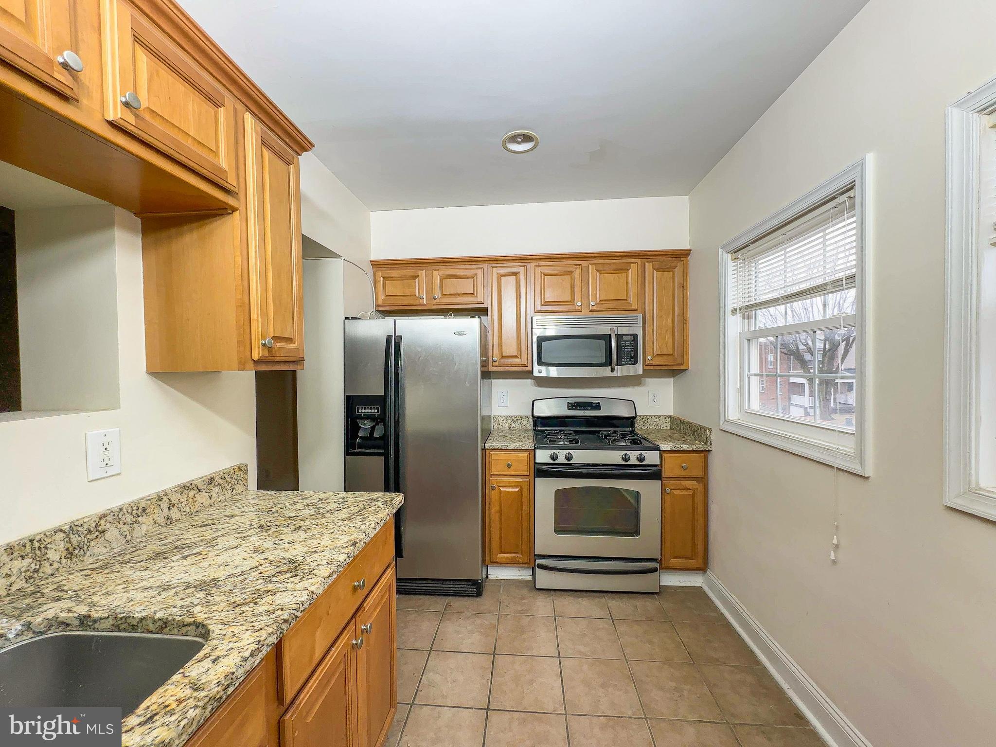 1835 D Street Northeast Washington, DC 20002 - Photo 28 of 42 a kitchen with stainless steel appliances granite countertop a refrigerator stove and oven