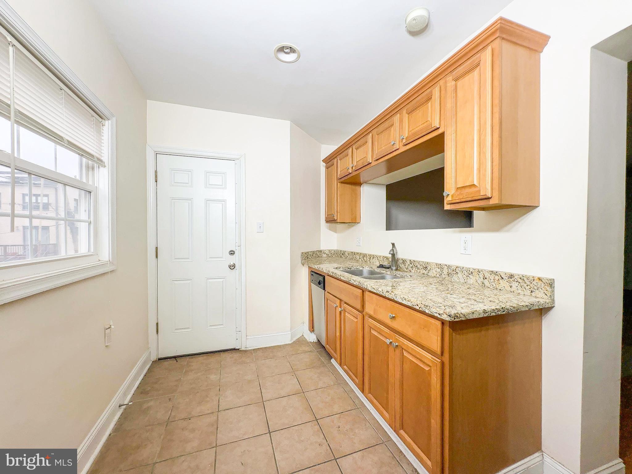 1835 D Street Northeast Washington, DC 20002 - Photo 29 of 42 a kitchen with granite countertop a sink and a stove